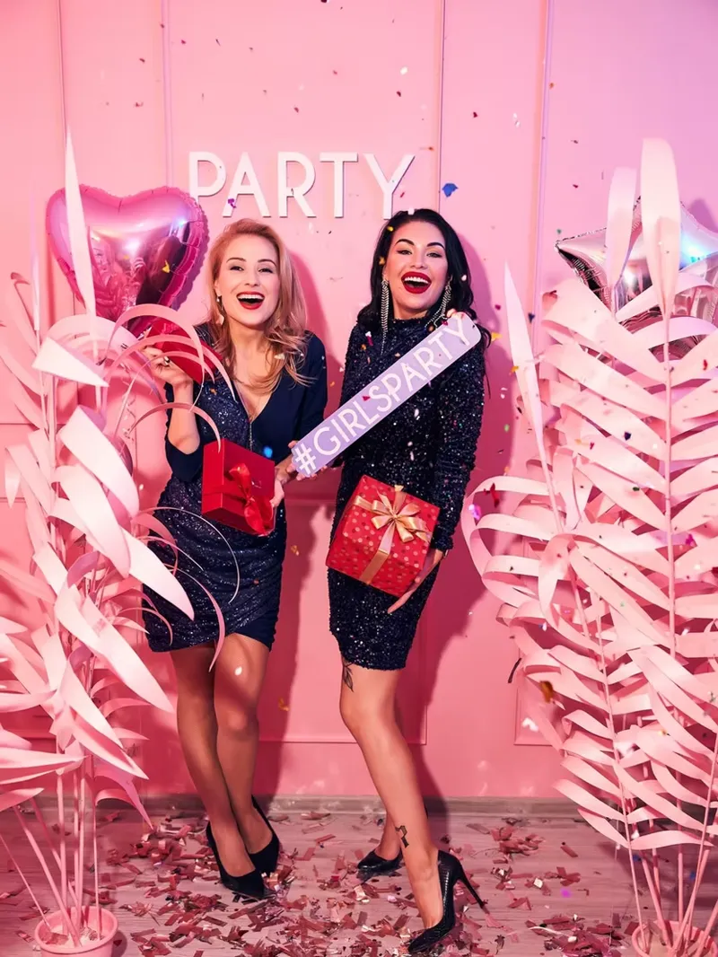 A hen party group photographed on the studio's pink set